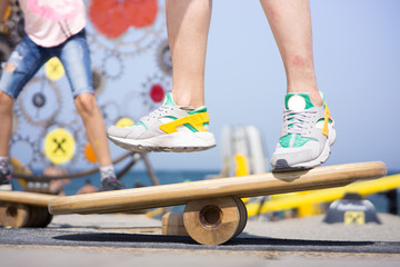 Balancing on a balance board in sunny weather at the beach