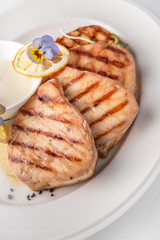 Grilled salmon fish fillet (red fish). Seafood. Banquet festive dishes. Fine dining restaurant menu. White background.