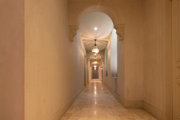 The hotel corridor is decorated in antique style.