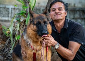 German Shepherd with Handler in Garden