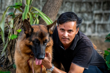 German Shepherd with Handler in Garden