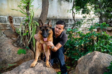 German Shepherd with Handler in Garden