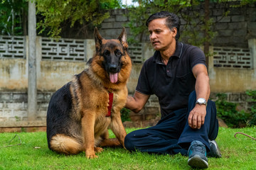 German Shepherd with Handler in Garden