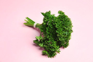Bunch of fresh green parsley on pink background