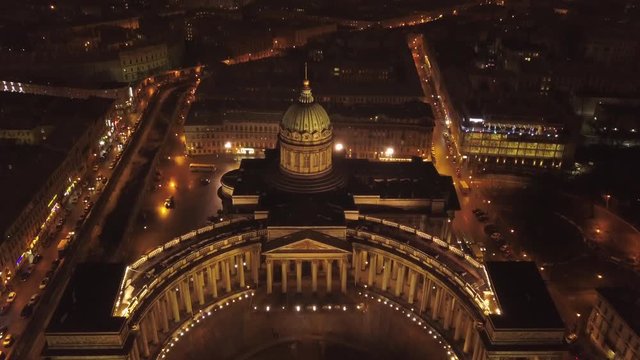 Night St. Petersburg city center, Kazan Cathedral, Nevsky prospect. Passing cars traffic and crowd of people at the bottom. Aerial footage