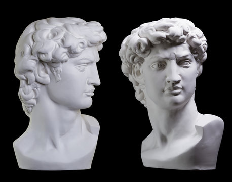 Statue. On a black isolated background. Gypsum statue of David's head. Man.