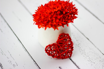 Red hearts and flowers on a white wood floor with space, ideas love or the day of love Valentines Day