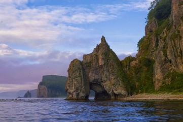Stacks with archs on the Tatar strait coast. Sikhote-Alin mountain ridge. Khabarovsk region, far East, Russia.