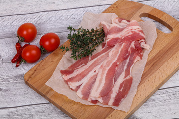 Raw bacon on the board