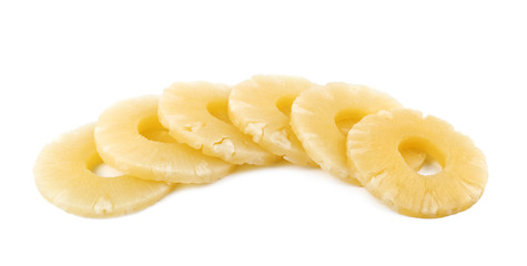 Slices of delicious sweet canned pineapple on white background