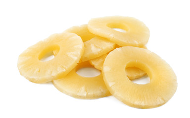 Slices of delicious sweet canned pineapple on white background