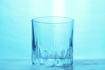 Empty glass on blue background