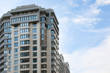 Modern building with tinted windows against sky. Urban architecture