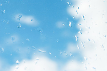 raindrops on the window. autumn summer background blue sky