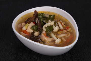Thai style soup with meat and mushrooms
