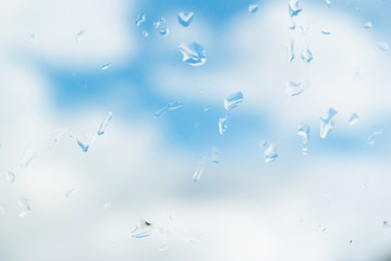 raindrops on the window. autumn summer background blue sky