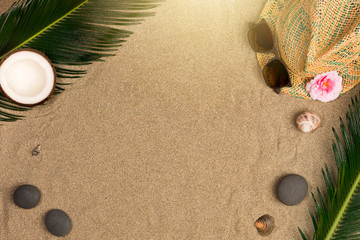 Fototapeta na wymiar Summer flat lay with, sunglasses and panama hat on sand background