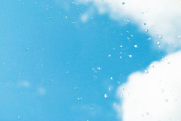 raindrops on the window. autumn summer background blue sky