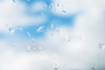 raindrops on the window. autumn summer background blue sky