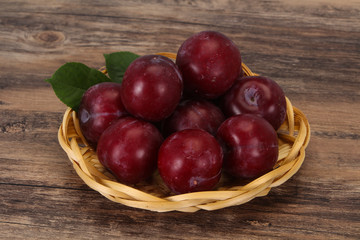 Plum heap in the wooden basket
