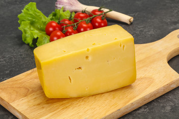 Hard yellow tasty cheese brick