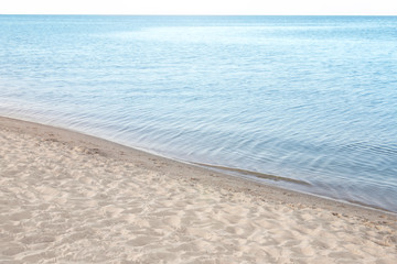 Fototapeta na wymiar View of sea water and beach sand on sunny summer day
