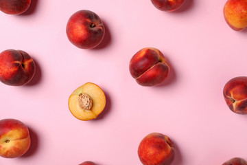 Flat lay composition with sweet juicy peaches on pink background