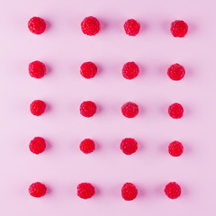 Pattern of raspberries on pink background. Colorful diet and healthy food concept. Background of raspberries. Top view. Flat lay. Copy space
