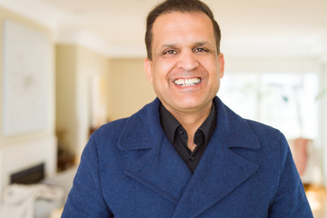 Middle age man smiling confident to the camera at home