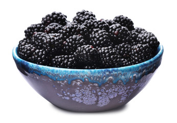 Blue bowl of tasty ripe blackberries on white background
