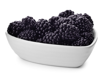 Bowl of tasty ripe blackberries on white background
