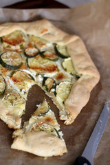 Homemade galette with zucchini and feta cheese. Selective focus.