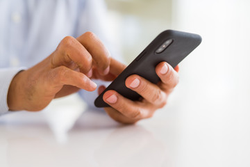Close up of business man hands using smarpthone