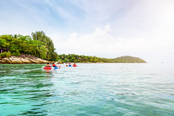 Fototapeta na wymiar Tourist group are kayaking on the sea, travel by boat to see the beautiful nature landscape in the morning of summer at front the resort around Ko Lipe island, Tarutao National Park, Satun, Thailand