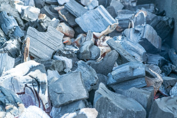 Barbecue grill with flaming and hot coal briquettes for barbecue, close-up