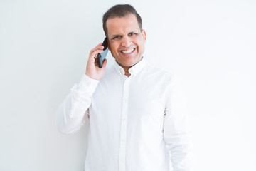 Middle age man calling using smartphone with a happy face standing and smiling with a confident smile showing teeth