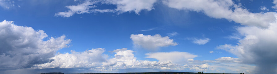 Clouds against the blue sky. Atmospheric phenomenon-vaporization, visible to the naked eye, panorama.