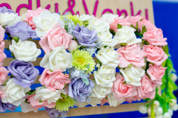Assortment in the shop of hoops with artificial flowers handmade hair for women.