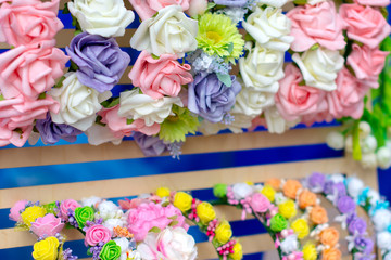 Assortment in the shop of hoops with artificial flowers handmade hair for women.