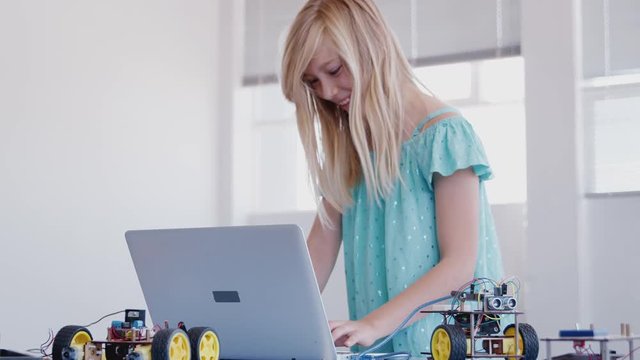 Female Student Building And Programing Robot Vehicle In After School Computer Coding Class 