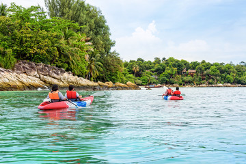 Fototapeta na wymiar Tourist group are kayaking on the sea, travel by boat to see the beautiful nature landscape in the morning of summer at front the resort around Ko Lipe island, Tarutao National Park, Satun, Thailand