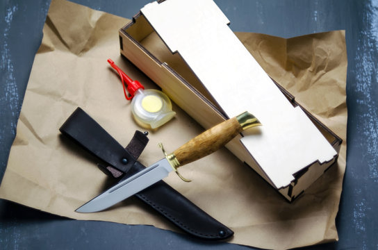 Copy of the knife of Soviet intelligence officers and the people's commissariat of in USSR NKVD knife, 1934 in a gift box with leather sheath and oil for impregnation  a dark background.