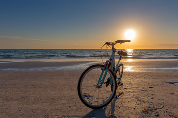 Fototapeta premium Bike on a Beach at Sunset