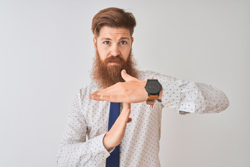 Young redhead irish businessman standing over isolated white background Doing time out gesture with...