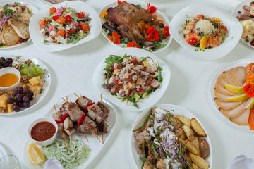 Beautiful festive table served for wedding celebration dinner at home or restaurant interior. Table full of food at a restaurant.  Full round table.