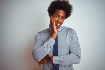 Fototapeta na wymiar American business man with afro hair wearing shirt and tie over isolated white background thinking looking tired and bored with depression problems with crossed arms.