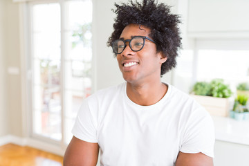 Fototapeta premium African American man wearing glasses smiling looking side and staring away thinking.