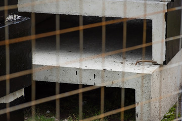 Fototapeta na wymiar Metal fence mesh with precast concrete in black paint