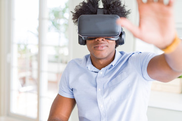 African amaerican man having fun playing with virtual reality glasses