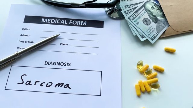Diagnosis sarcoma in a medical form on the doctor desk